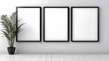 Three empty frames on a wall with a plant in front photo