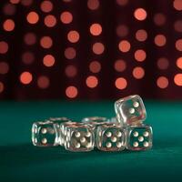 Transparent dice with white dots on green casino table with red bokeh background gambling luck game night concept photo