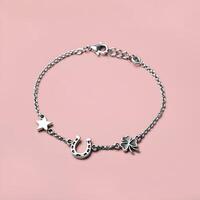 Silver charm bracelet with a horseshoe four leaf clover and star charms on soft golden bokeh background photo