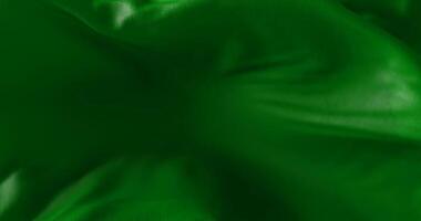 Green cloth or silk waving at wind in slow, loop video