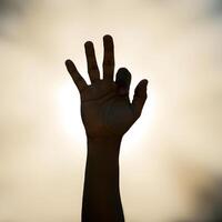 Outstretched hand reaching towards warm sunlight with bokeh effect symbolizing hope new beginnings photo
