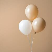 Beige and white balloons floating with delicate ribbons against neutral background minimal elegant party decor concept photo