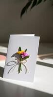 Elegant minimalist empty card copy space with tied flower bouquet in a soft natural sunlight casting delicate shadows photo