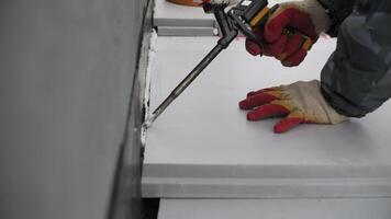 Worker Installing Foam Insulation Panels with Sealant video