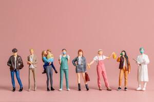 Miniature figurines of women representing diverse professions A perfect visual for International Womens Day photo