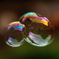 Floating soap bubble reflecting rainbow colors with water surface in night background surreal magical abstract concept photo