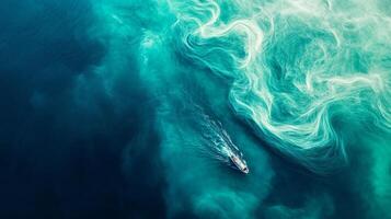 Aerial view of boat navigating stunning swirling turquoise ocean currents photo
