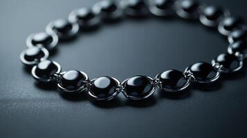 Elegant black onyx necklace with silver chain on dark surface photo
