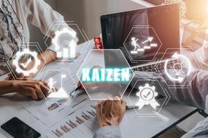KAIZEN concept, Business person team working on laptop and analyzing financial data with kaizen icon on virtual screen, Business philosophy and corporate strategy concept of continual improvement. photo