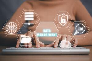 Data management concept, Person hand typing on keyboard with data management icon on virtual screen, information technology concept. photo