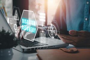 Disaster Recovery concept, Person hand using laptop computer with Disaster Recovery icon on virtual screen photo