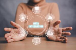 Data integration concept, Person hand holding data integration icon on virtual screen. photo