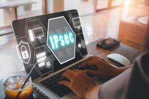 IPSec, Internet and Protection Network concept, Person using laptop computer on desk with IPsec icon on virtual screen. photo