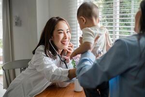 Pediatrician interacting with a baby during a checkup, showcasing a caring medical environment. photo