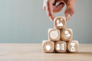 Wooden blocks with challenge icons representing goals, success, and teamwork. Perfect for business and personal development themes. photo