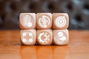 Wooden blocks with procurement management icons symbolizing strategy, efficiency, and business processes. photo