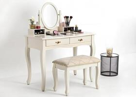 A white vanity table with a mirror and stool photo