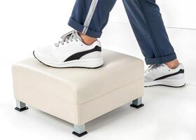 A person standing on a foot stool with their shoes on photo