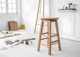 A stool in a room with a ladder and other tools photo