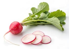 A fresh radish with vibrant green leaves rests on a white background photo