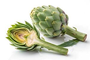 Two artichokes on a white background, one whole and the other cut in half photo