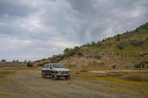 Gaziveren Cyprus -15.02.2025 Off-road adventure in rugged terrain under an overcast sky in a remote area photo