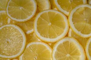 Fresh lemon slices arranged artistically on a bright background, showcasing their vibrant color and texture photo