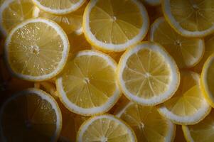 Brightly sliced lemons create a vibrant pattern in natural light during a summer afternoon photo