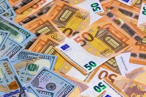 Colorful mix of European and American currency scattered on a flat surface photo
