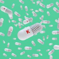 Close-up of a pill capsule with the label Vitamin K photo