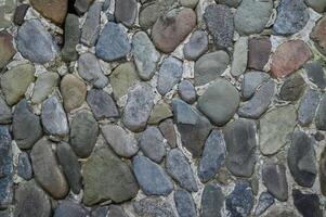 Natural stone wall creates rustic charm in a serene garden setting at dusk photo