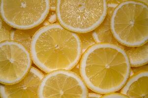 Bright yellow lemon slices create a vibrant and refreshing pattern for culinary inspiration and decor photo