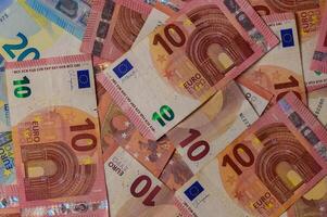 Colorful collection of euro banknotes spread across a surface, showcasing intricate designs and vivid hues photo