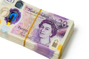 Stacks of British twenty pound notes displaying the portrait of a notable monarch photo