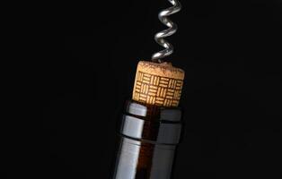 Uncorking a fine bottle of red wine for an evening celebration of culinary delights photo