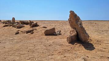A row of stones stands in the desert, used as a direction for movement photo