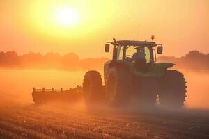 Tractor plowing at sunset, serene agricultural scene with golden glow photo