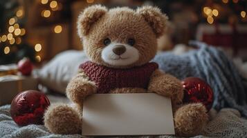 A teddy bear holding a blank sign in front of christmas decorations photo