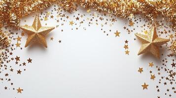 Gold stars and tinsel on a white background photo
