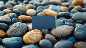 Blank card mockup on smooth stones background photo