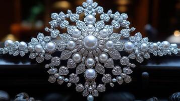 A large white pearl and diamond brooch on a table photo