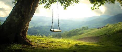 A serene landscape featuring a swing hanging from a tree, surrounded by lush greenery and distant mountains under a soft sky. photo