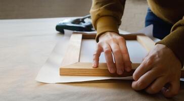 Hands stretching canvas on stretcher bars in workshop. Gallery wrap. Print on canvas. photo