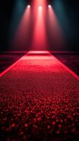 Dramatic red runway illuminated by glowing lights during an evening fashion event photo