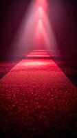 Bright red runway illuminated by dramatic lights creates an enchanting atmosphere for an event photo