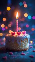 Delicious birthday cake adorned with hearts and a glowing candle in a festive setting photo