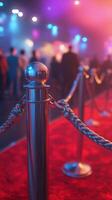 Excitement builds at a glamorous event with a red carpet and velvet ropes under colorful lights in the evening photo