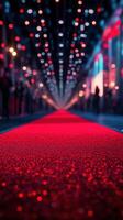 Bright red carpet illuminated by colorful lights at an extravagant event during the night photo