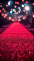 Red carpet leading to an elegant venue surrounded by shimmering lights at night photo