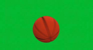 Rotating basketball spinning in the air on a green background with realistic texture and smooth motion. Sports concept video